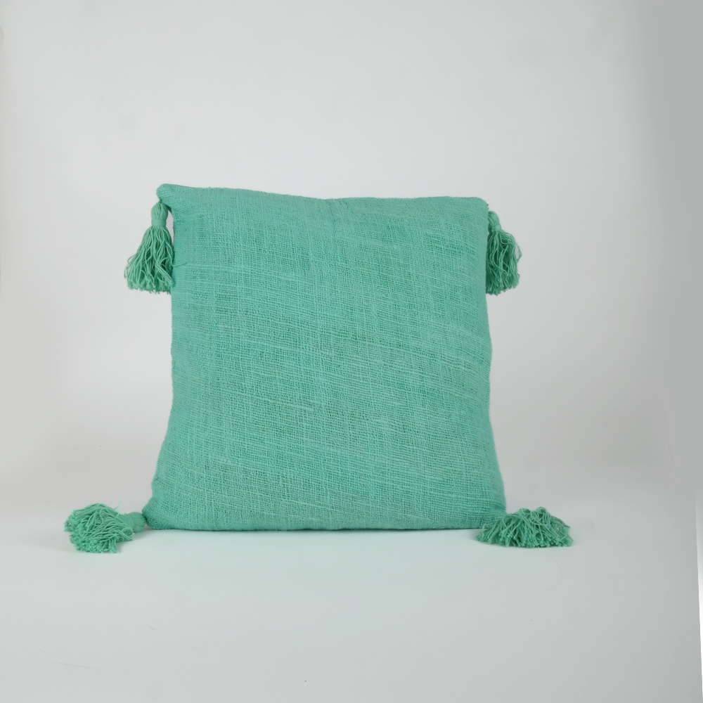 Housse de coussin turquoise avec pompons